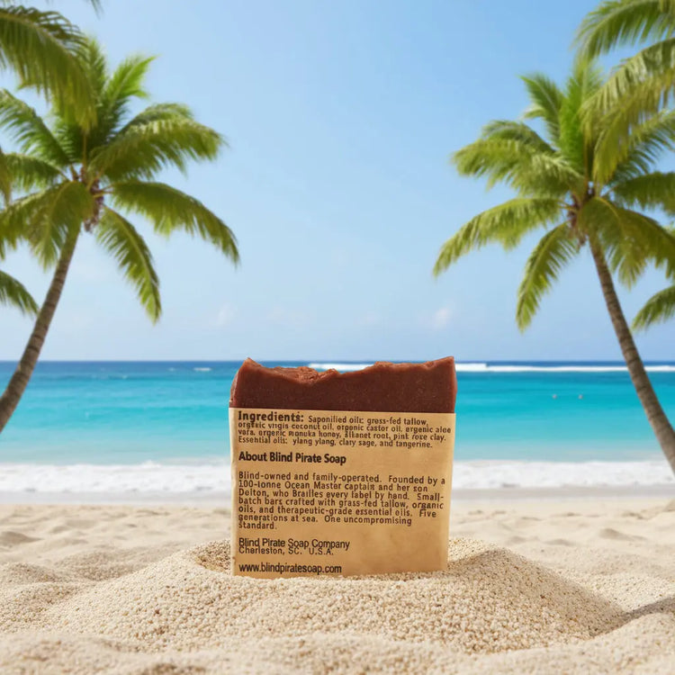 Alani Moani Tallow Soap on a white sandy beach with Hawaiian palms swaying to the sea breeze