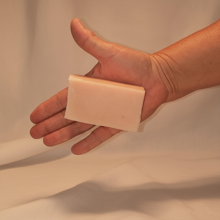 Rustic cut Coconut Rose grass-fed tallow soap bar, creamy white with soft pink swirls. Blind Pirate Soap Co