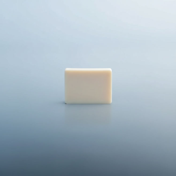 An unwrapped Pure tallow soap bar standing alone in a soft misty blue polar world, quiet and elemental against the vast arctic stillness.