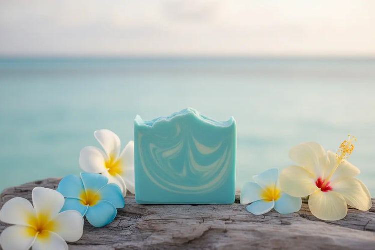 Soft blue marbled Ocean soap bar with gentle Exuma beach colors on coastal wood with calm ocean and tropical flowers