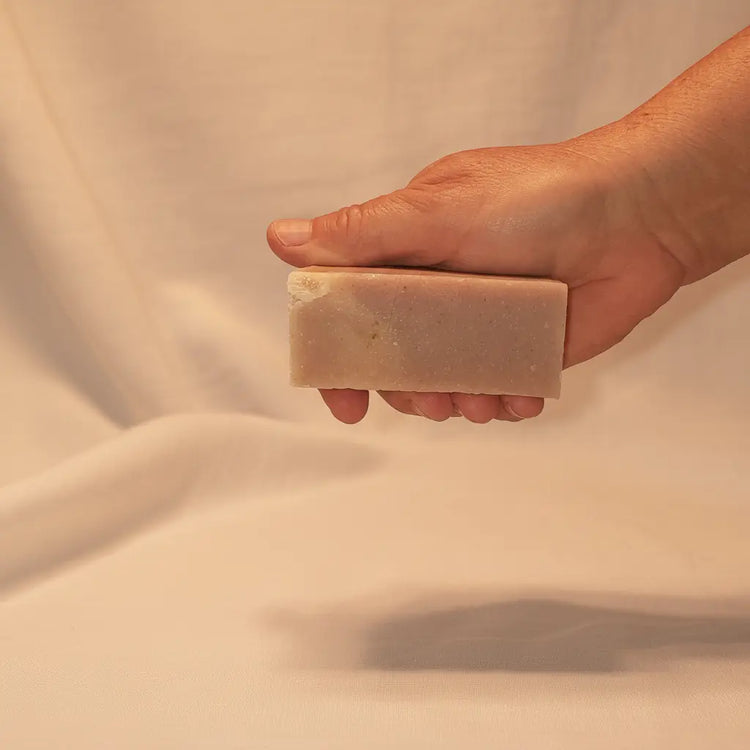 Rustic cut Petals & Loam grass-fed tallow soap bar, soft blush pink with earthy flecks. Blind Pirate Soap Co.