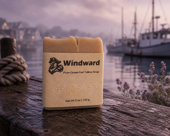 Windward tallow soap bar with label on wet dock, mooring rope, lavender, misty harbor at dusk. Blind Pirate Soap Co.
