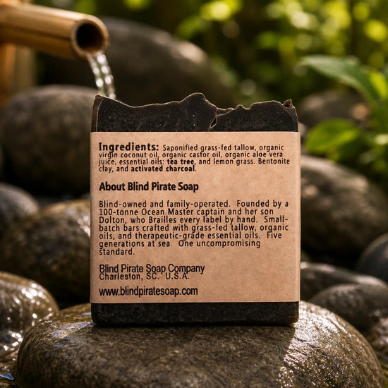 Black Flag back panel showing ingredients and braille label on volcanic rock with Zen foliage.