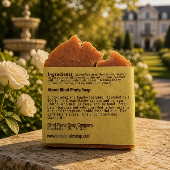 The Stable tallow soap bar, ingredients panel facing out, warm golden estate stable yard light. Blind Pirate Soap Co.
