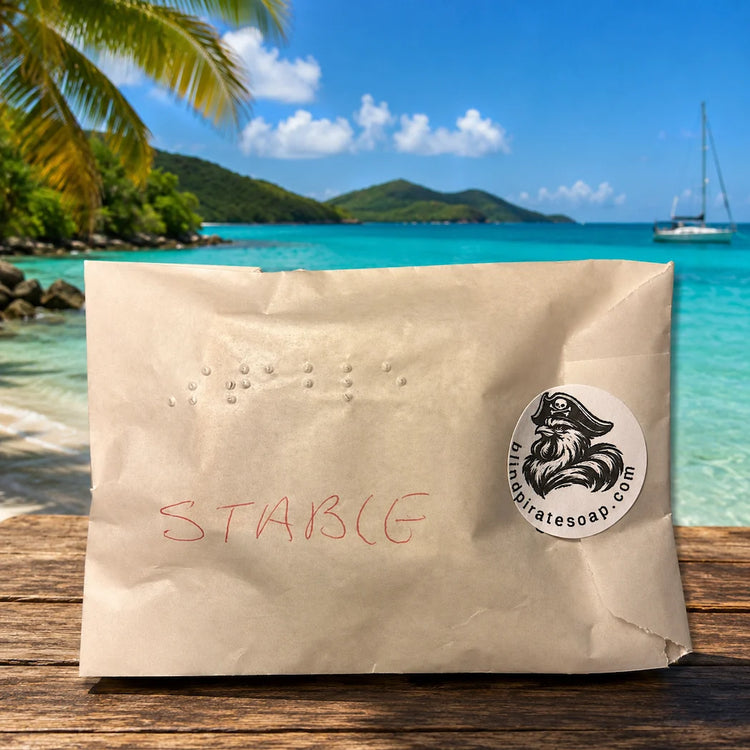 Stowaway Discovery Set | Single Braille-labeled glassine-wrapped Stowaway soap sample sealed with Blind Pirate Soap Co. logo sticker