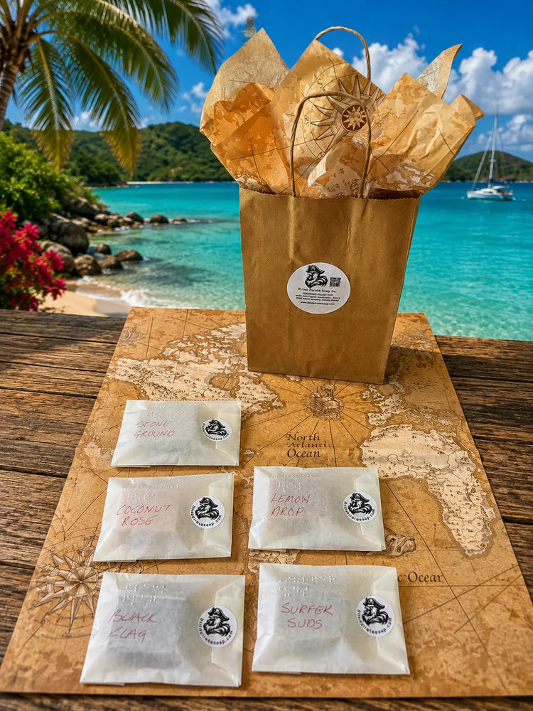 Stowaway Discovery Set flat lay — five Braille-labeled glassine-wrapped soap samples with Welcome Aboard cards, overhead view

