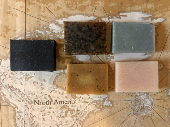 Four handcrafted tallow soap bars from the Stowaway Discovery Set, overhead flat lay on neutral surface
Blind Pirate Soap Co.