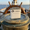 Ocean | Grass-Fed Tallow Soap Bar sits atop the pinnacle compass at the helm of a ship. Blind Pirate Soap Co.