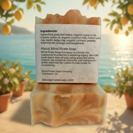 Amalfi Terrace | Back panel of Sunshine & Citrus tallow soap bar in a sun-dappled Mediterranean garden, citrus fruit trees glowing warmly all around.