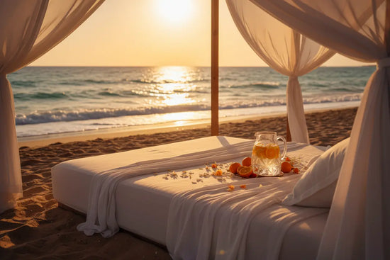 Beach Cabana | A canopied daybed draped in sheer linen on a golden shore, fresh citrus drinks catching the last warm light as gentle waves roll in.