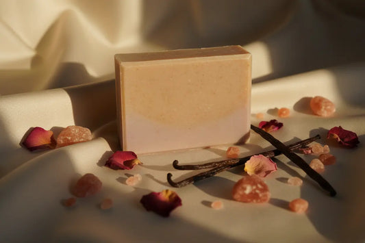 Elegant Silk and Salt soap bar on luxurious silk fabric with pink Himalayan salt, rose petals, and vanilla
