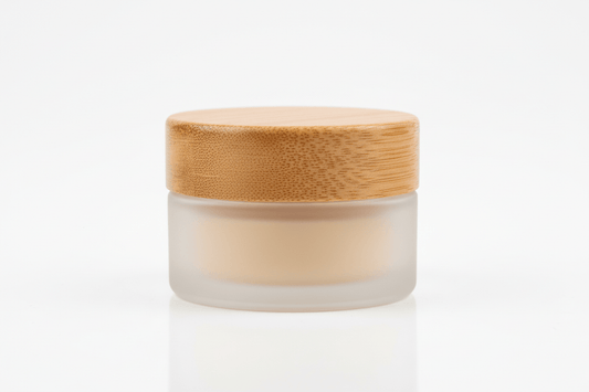 lip balm in a 1 oz frosted glass jar with a wooden bamboo looking lid