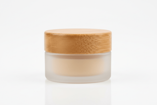 lip balm in a 1 oz frosted glass jar with a wooden bamboo looking lid