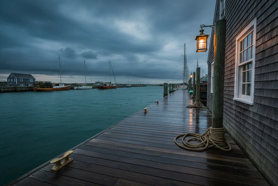 Nantucket Dock — Stormy Emerald Water sky reflects across a quiet quayside, lights beginning to glow in the stillness