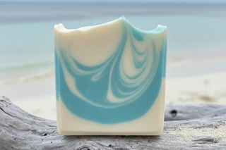 Ocean handcrafted soap bar with soft natural blue swirls in gentle turquoise and powder blue tones like Exuma beach water on driftwood
