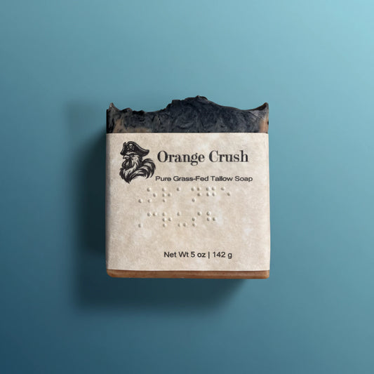 Orange Crush | Grass Fed Tallow Soap Bar Blind Pirate Soap Co. braille  labeled on the front of the label.