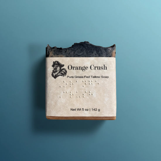 Orange Crush | Grass Fed Tallow Soap Bar Blind Pirate Soap Co. braille  labeled on the front of the label.