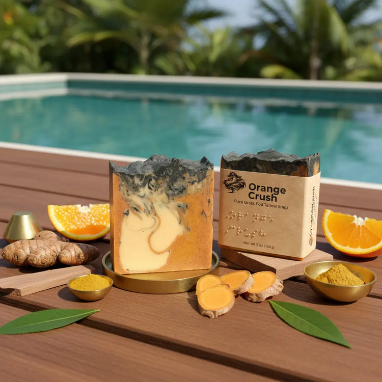 Unwrapped and eco-wrapped Orange Crush tallow soap bars on a sun-warmed pool deck beside fresh orange slices, turquoise water lapping alongside.