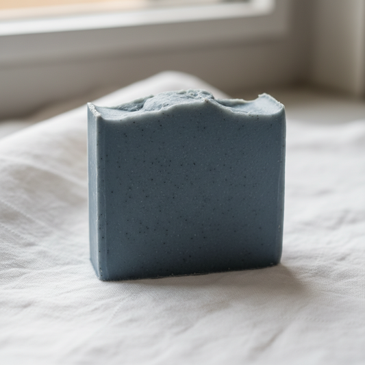 Sea Breeze standard cut soap bar, solid blue-grey from Cambrian clay, unlabeled on white linen