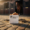 Oatmeal & Honey Certified Grass-Fed Tallow Soap bar in a stable yard with a horse, Blind Pirate Soap Co.