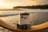 Surfer Suds tallow soap bars stacked on lacquered wood, glowing in golden light on the legendary surf beach of Nias, Indonesia