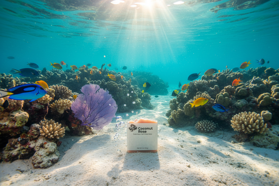 Tropical Fish  swim around Coconut Rose tallow soap bar nestled on the sandy ocean floor between vivid coral reef, warm sunlight rippling through turquoise depths.